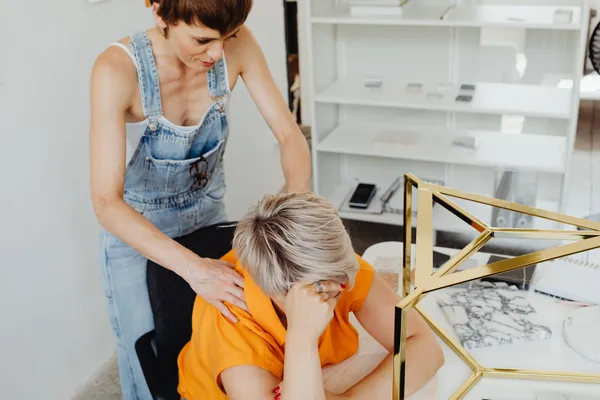 Two women enjoying a relaxing back massage in a comfortable office setting.